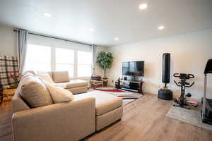 Living area featuring wood finished floors and recessed lighting