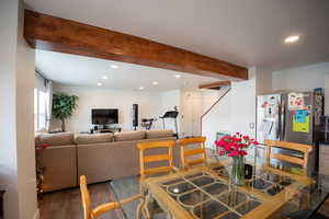 Dining area with beam ceiling, recessed lighting, and wood finished floors