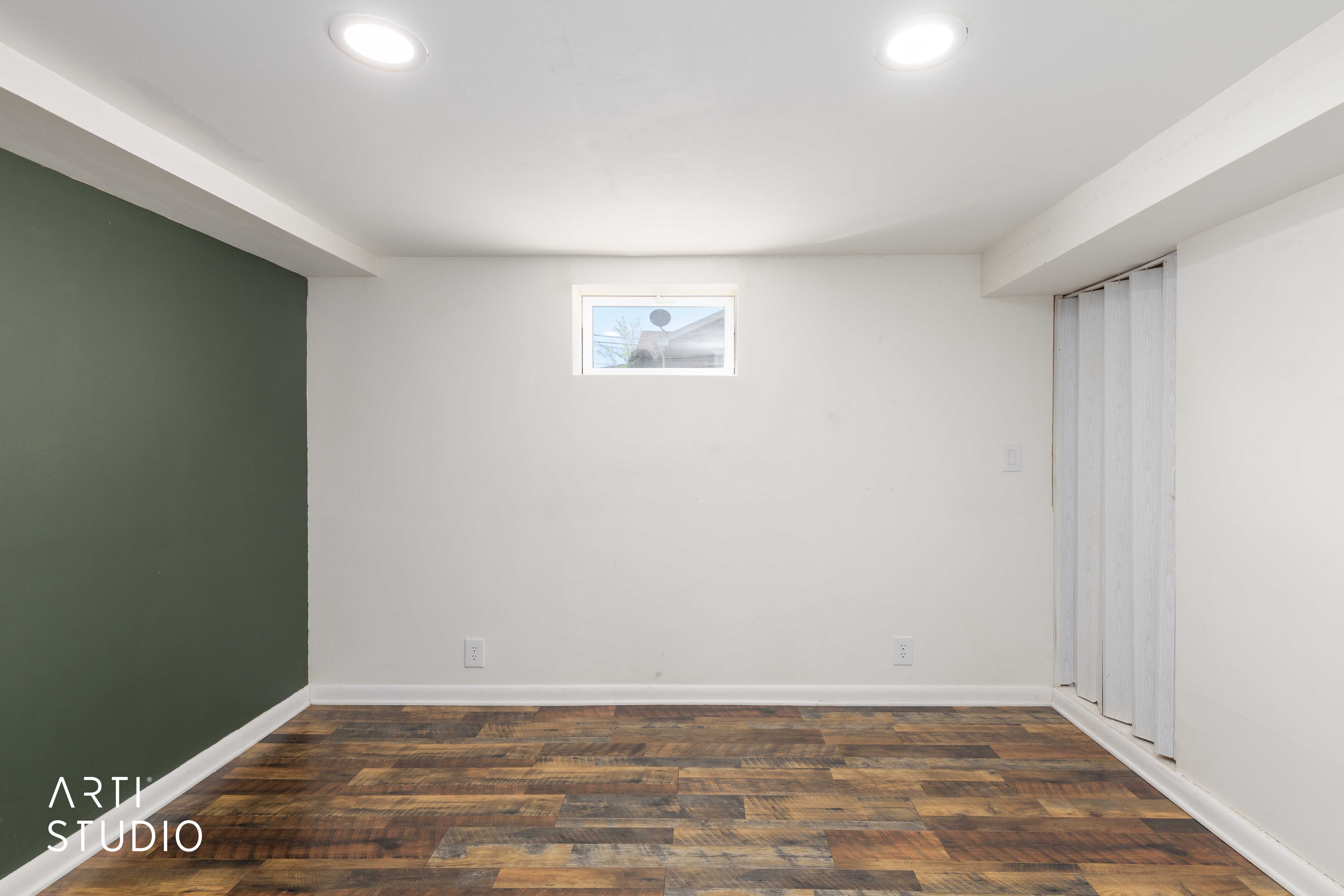 Downstairs bedroom featuring dark wood finished floors