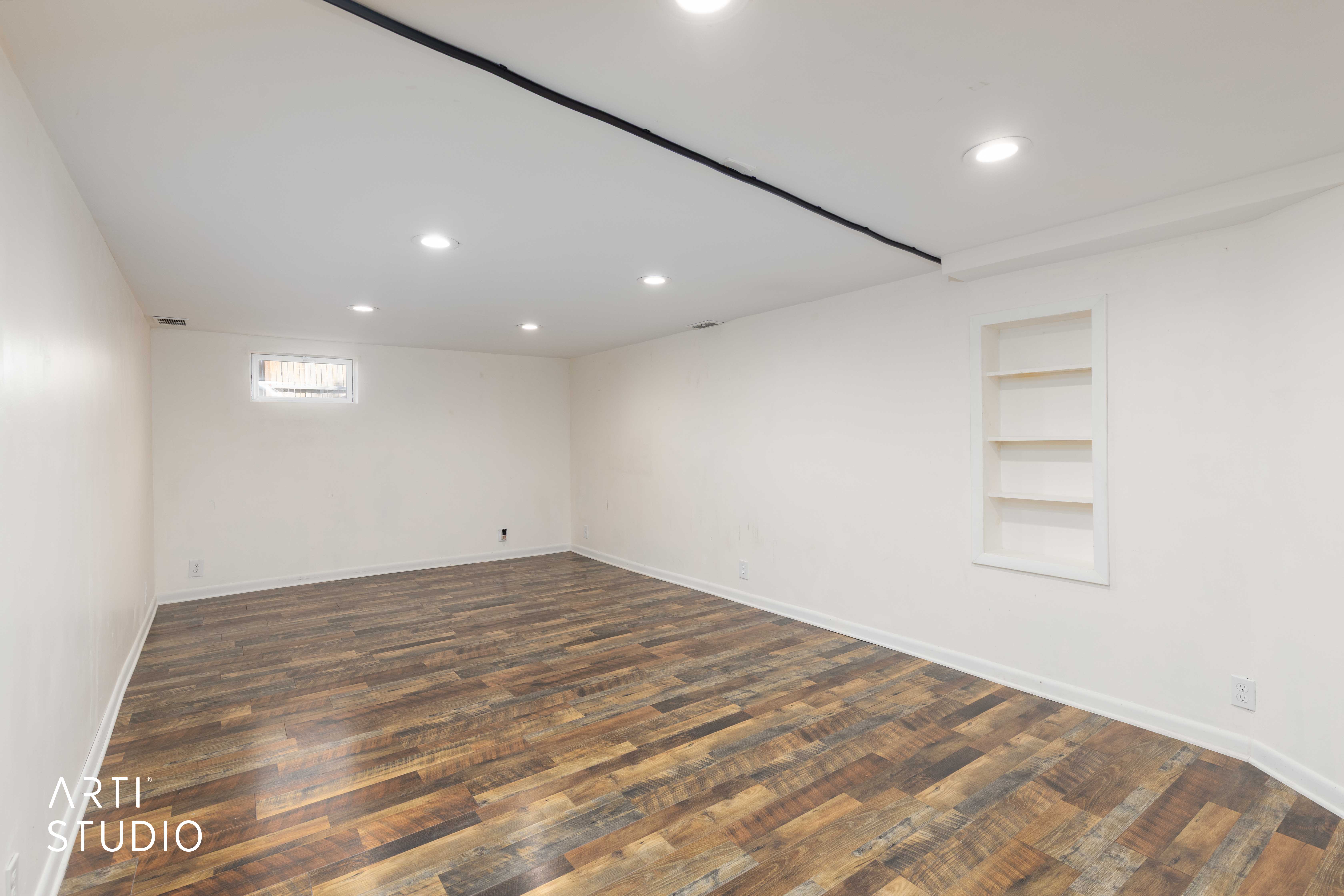Downstairs area with built in shelves, dark wood-style flooring, and recessed lighting