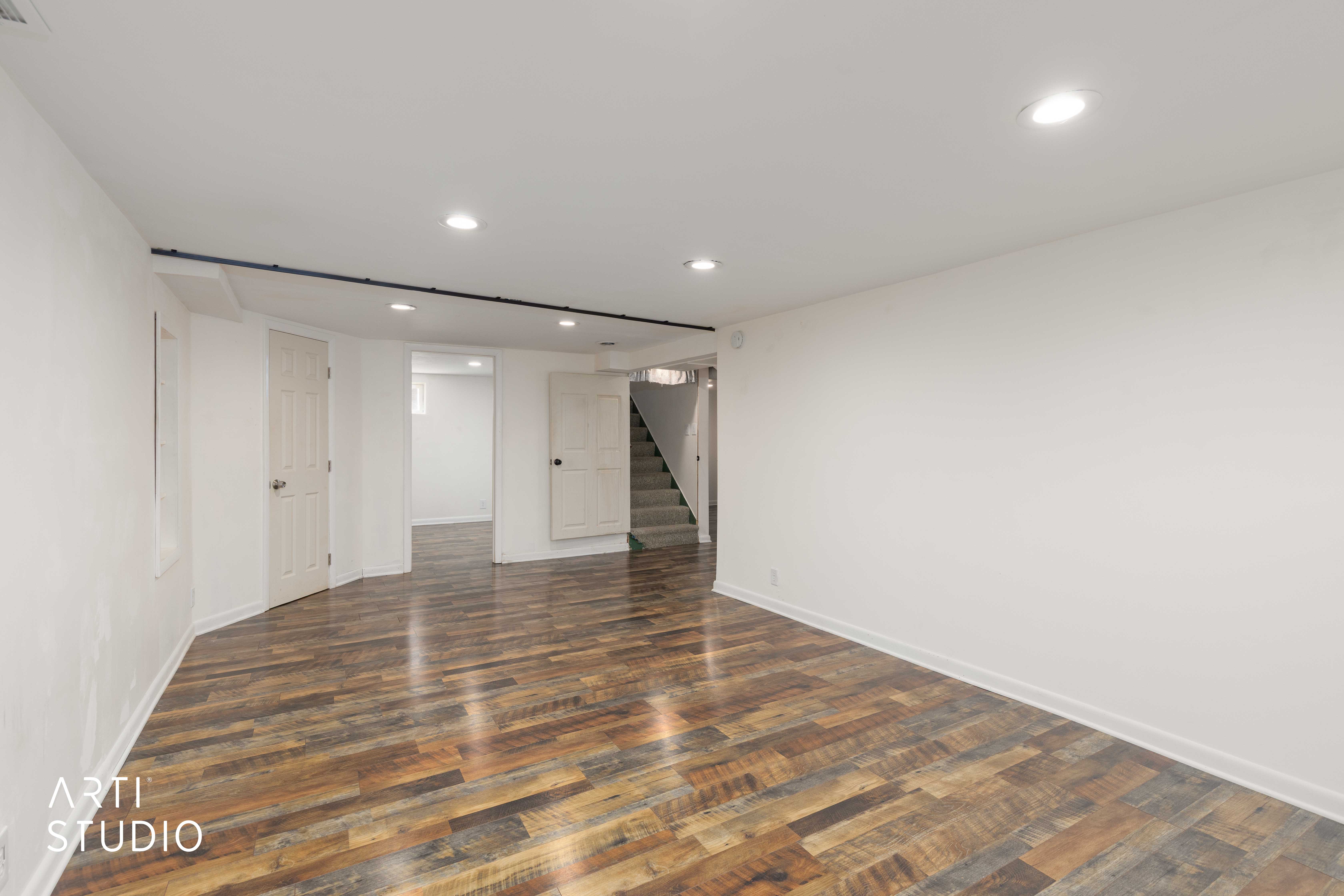 Downstairs family room featuring recessed lighting and dark wood-type flooring