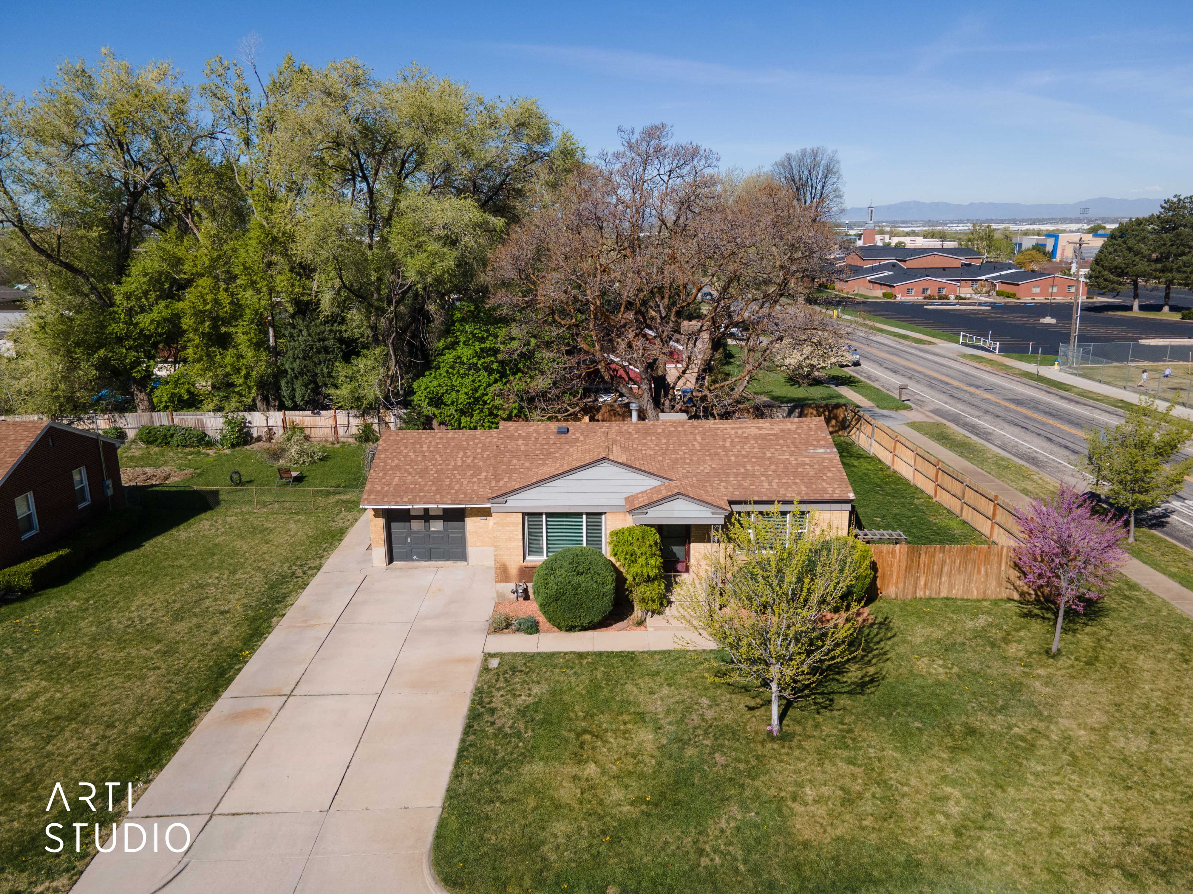 View of front of property featuring driveway, a garage, and a residential view