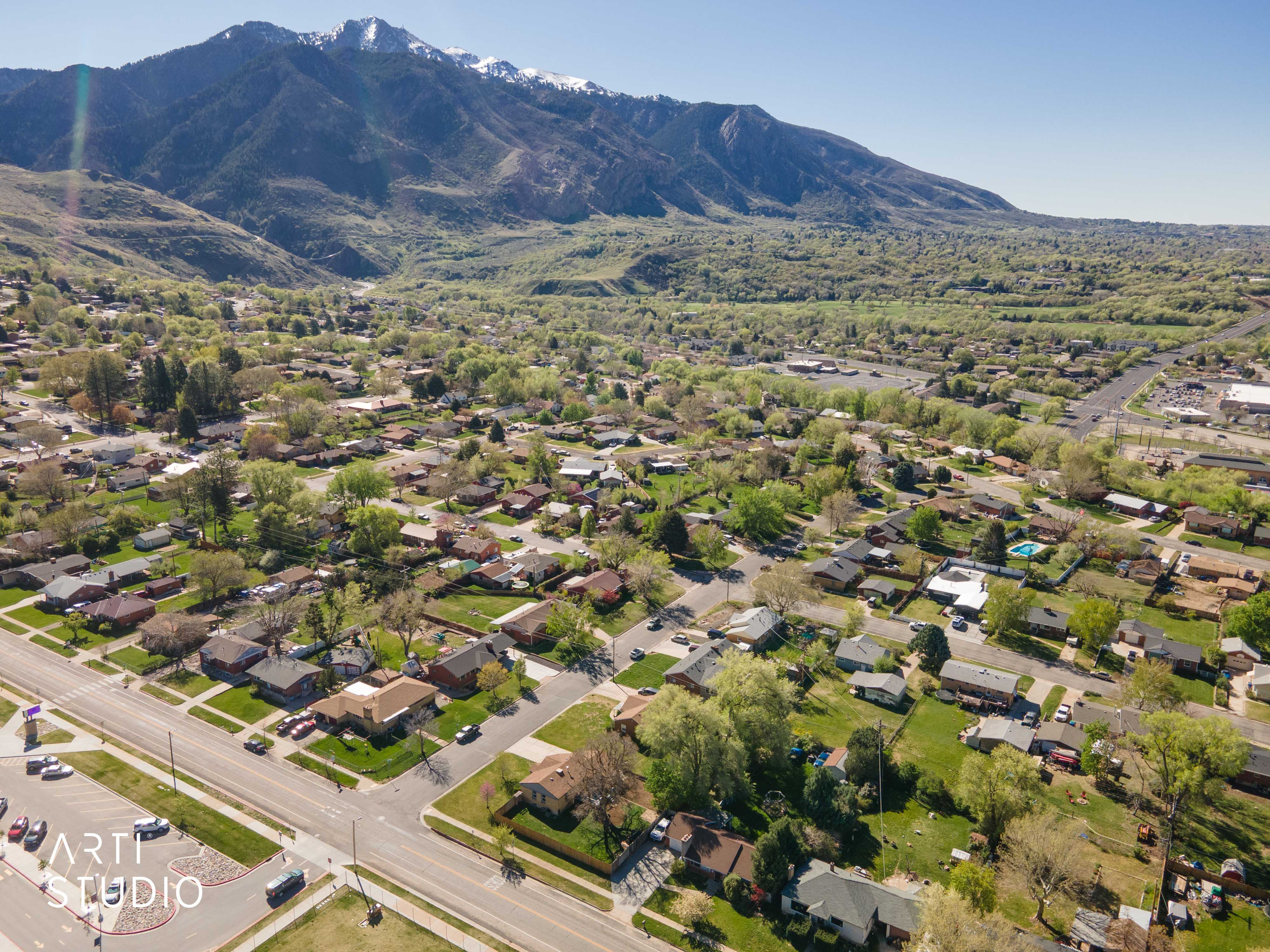 Aerial overview of property's location with mountains and nearby suburban area