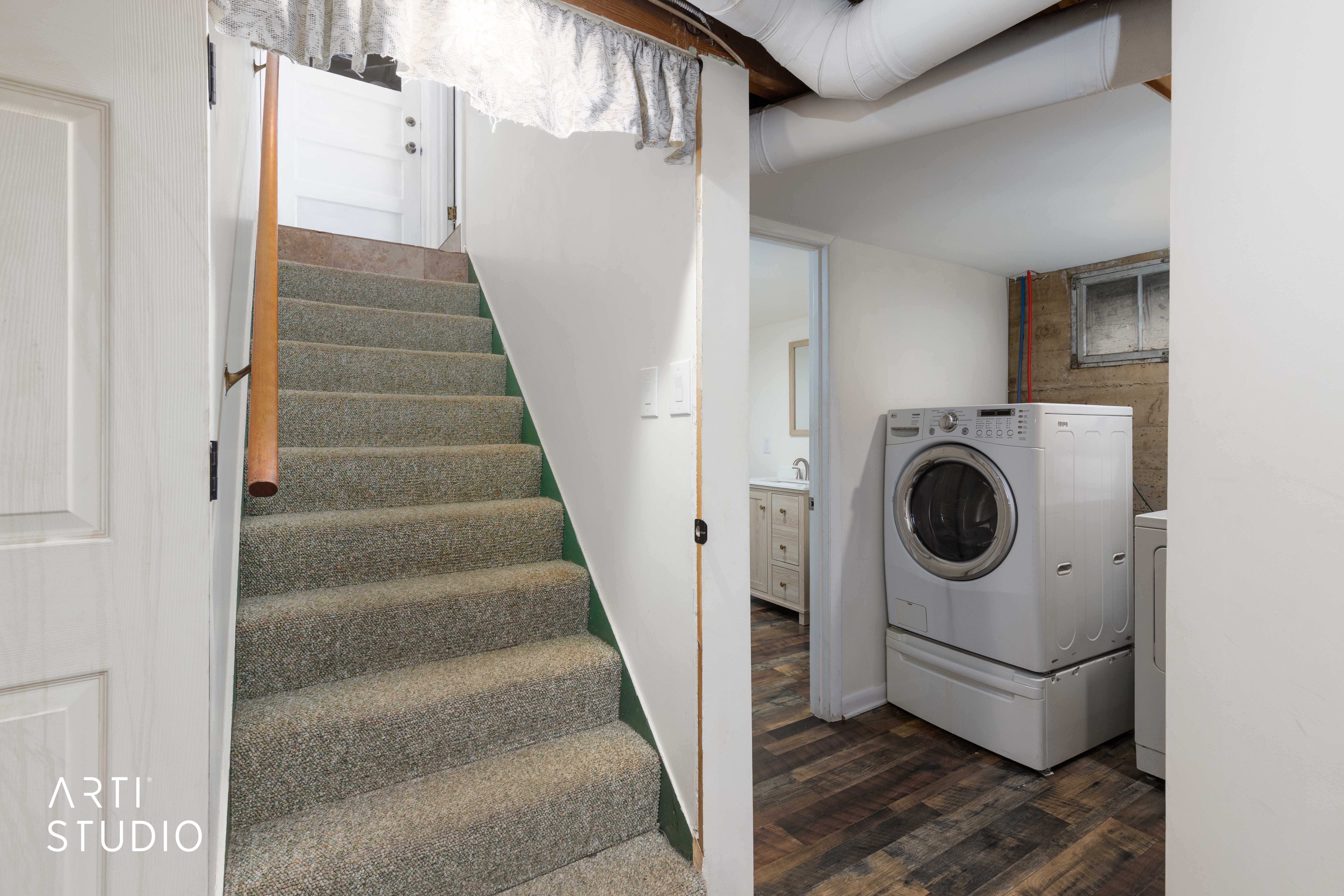 Laundry area featuring dark wood finished floors and washing machine and clothes dryer