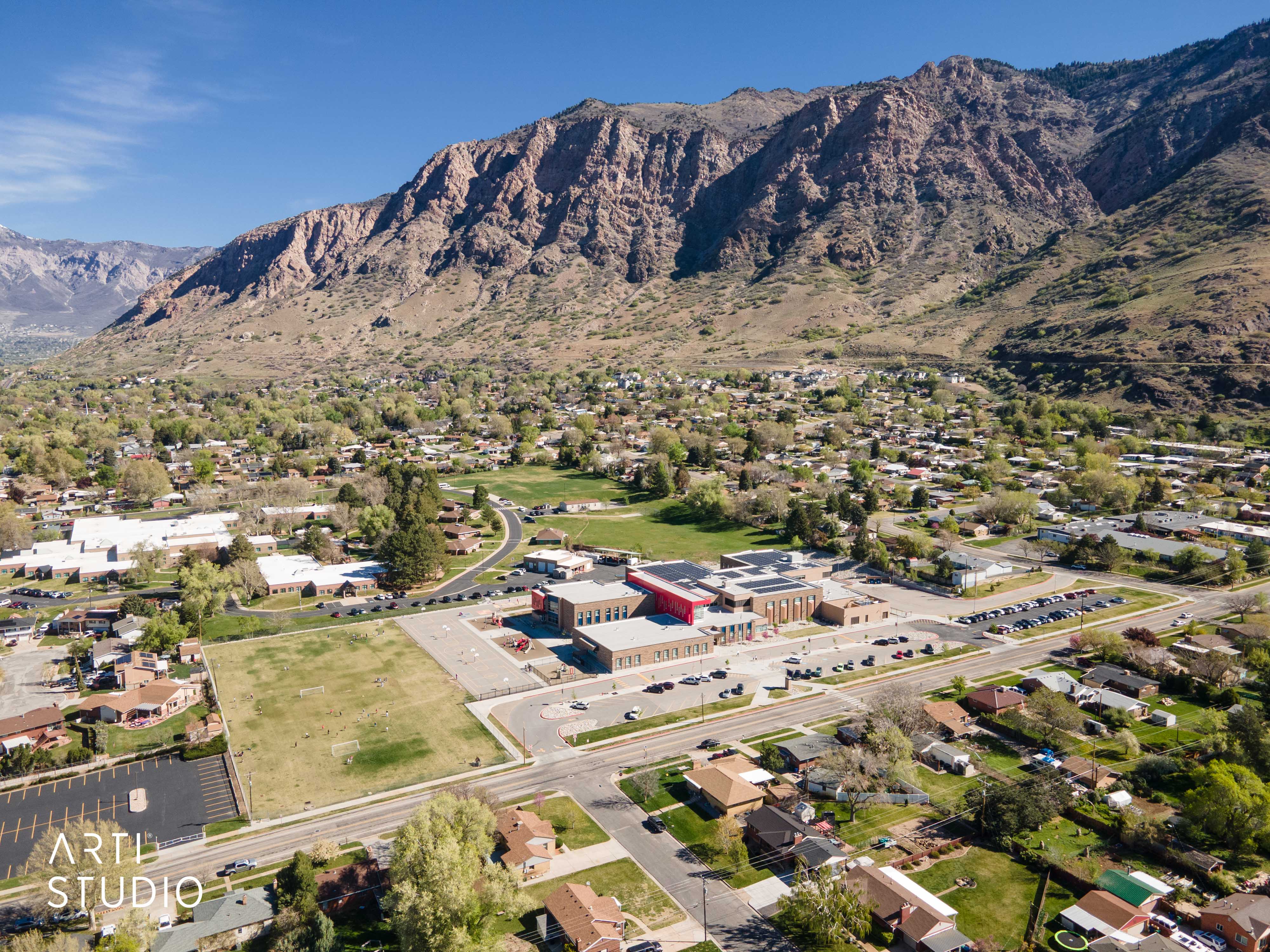 Aerial overview of property's location with nearby suburban area and a mountain backdrop