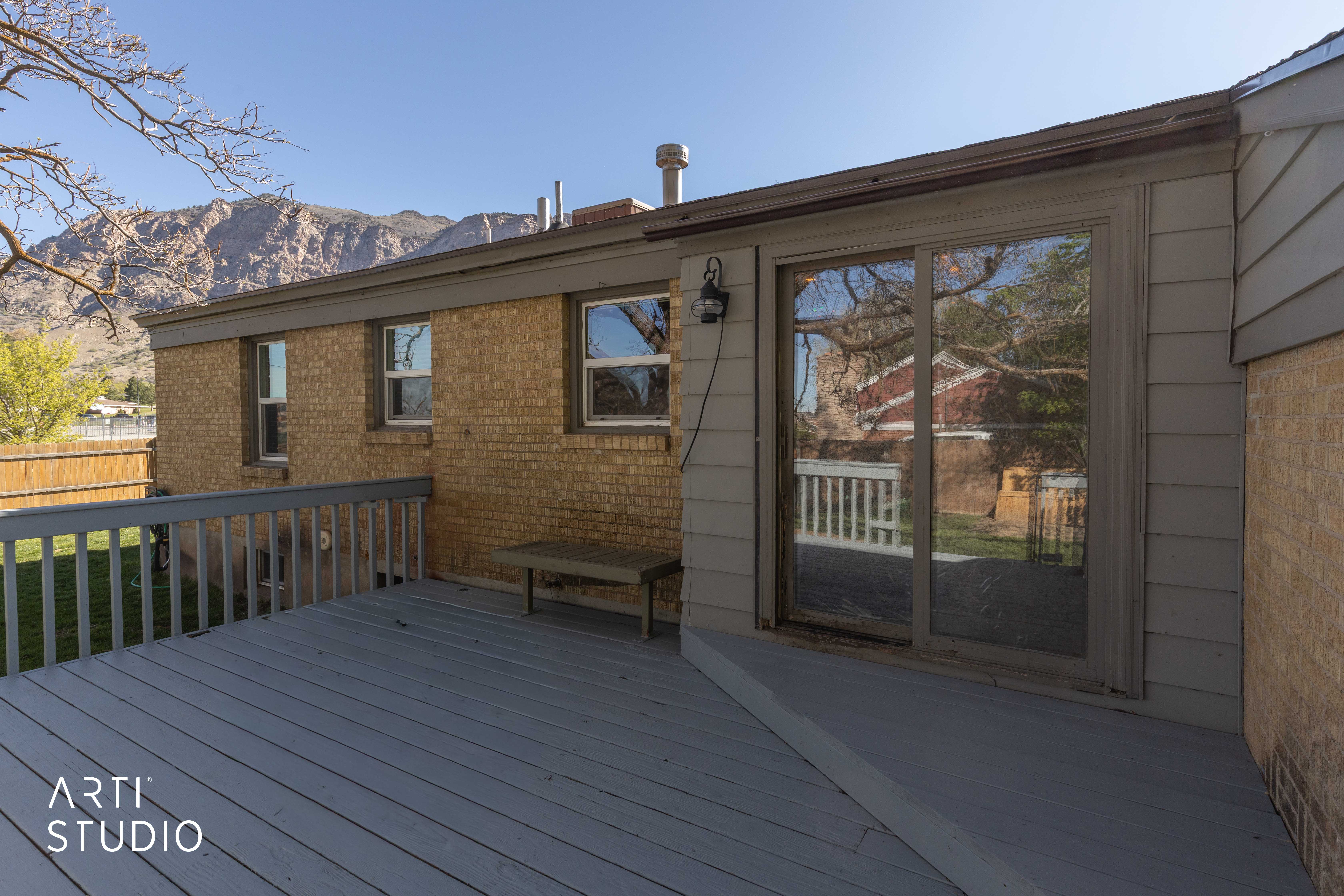 Wooden deck on west facing side of home, featuring a mountain view