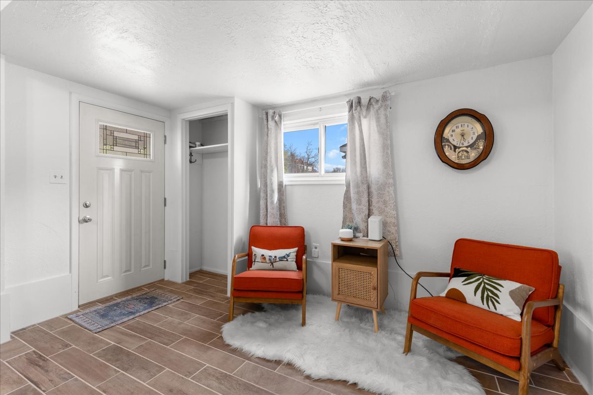 Sitting room with a textured ceiling and wood finish floors