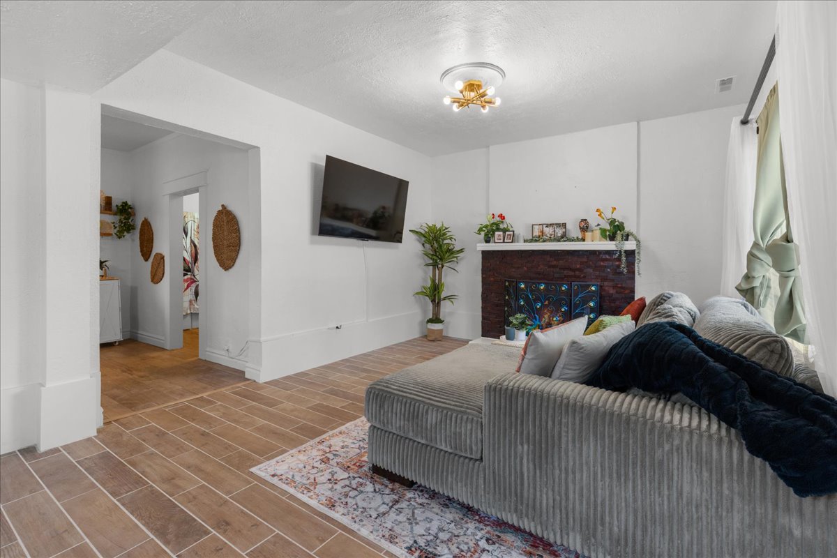 Living room featuring wood finish floors and a textured ceiling