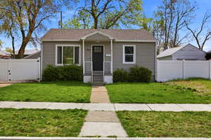 Bungalow with a gate, roof with shingles, and a porch