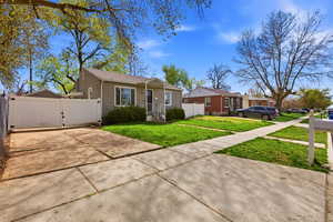 Bungalow-style home with a gate and concrete driveway