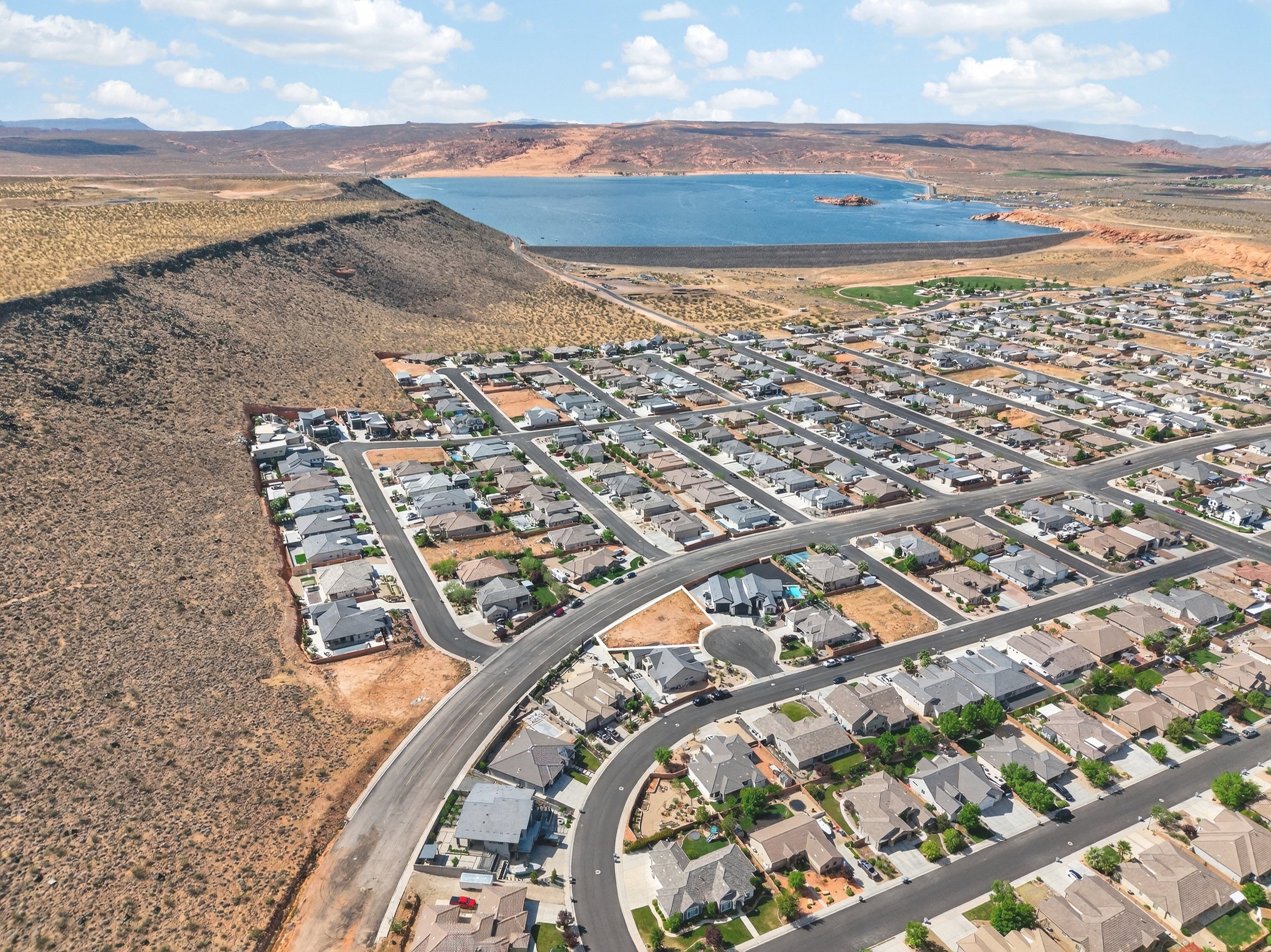 Aerial perspective of suburban area with a water and mountain view