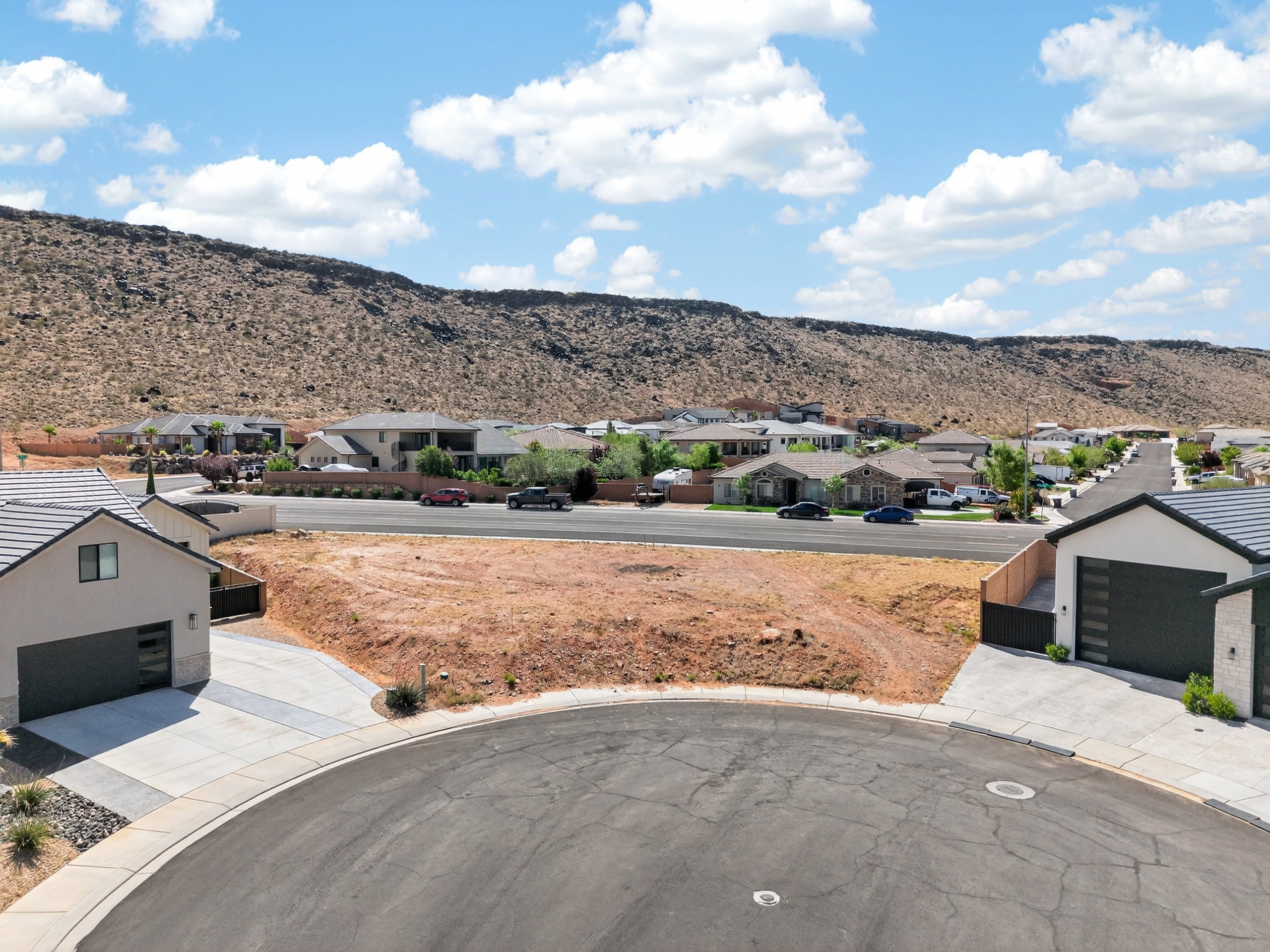 View of mountain backdrop featuring nearby suburban area