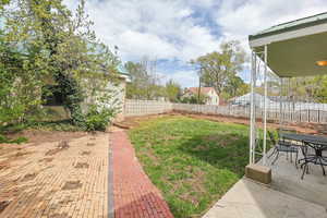 Fenced backyard featuring outdoor dining space and a patio