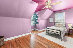 Bedroom 2 with hardwood lofted ceiling, and a ceiling fan