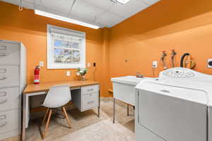 Laundry room featuring washer / dryer, a paneled ceiling, and an office area