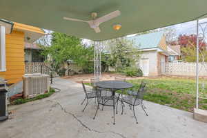 Fenced backyard with a patio area, outdoor dining space, area for grilling, and ceiling fan