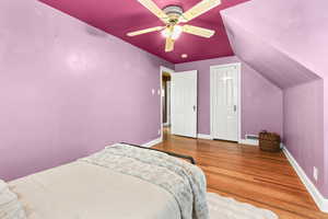 Bedroom 2 with hardwood lofted ceiling, and a ceiling fan