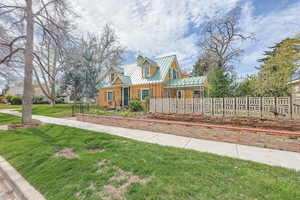 View of front of home featuring a standing seam roof and a chimney