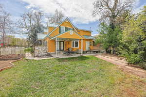 Back of house featuring a patio, a standing seam roof, and french doors