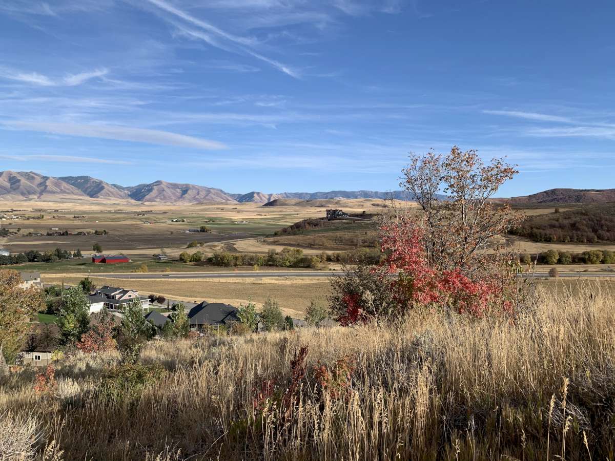 View of mountain backdrop with rural landscape