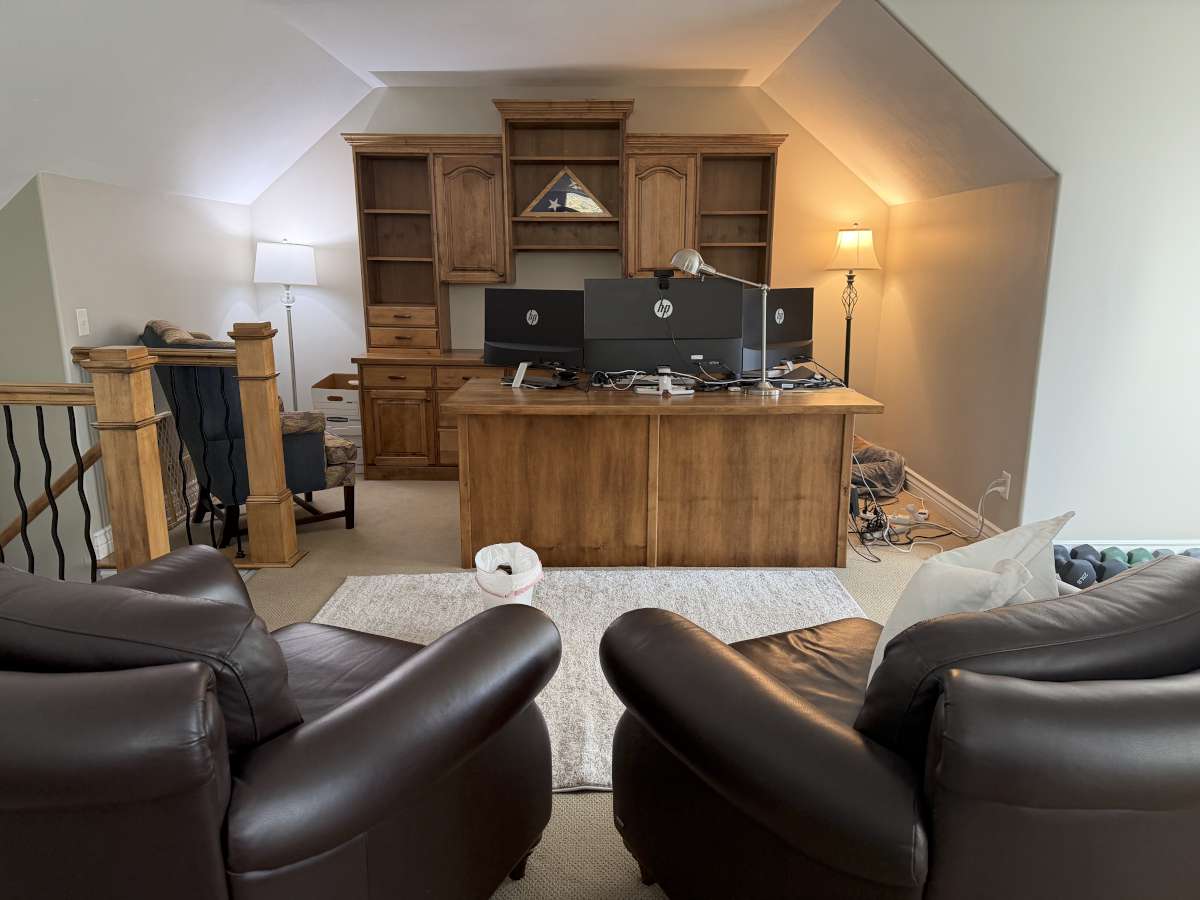 Home office featuring light colored carpet and vaulted ceiling