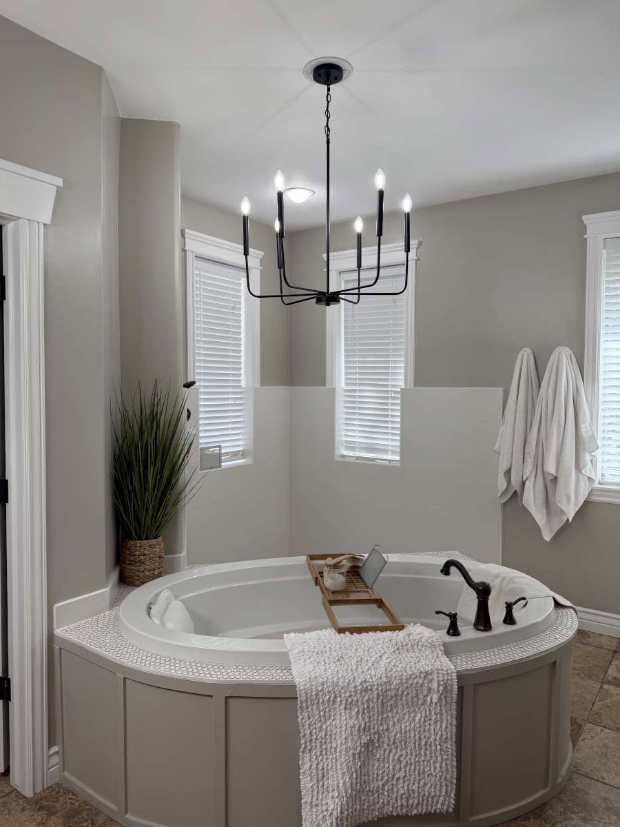 Full bath featuring a bath, plenty of natural light, and suspended lighting