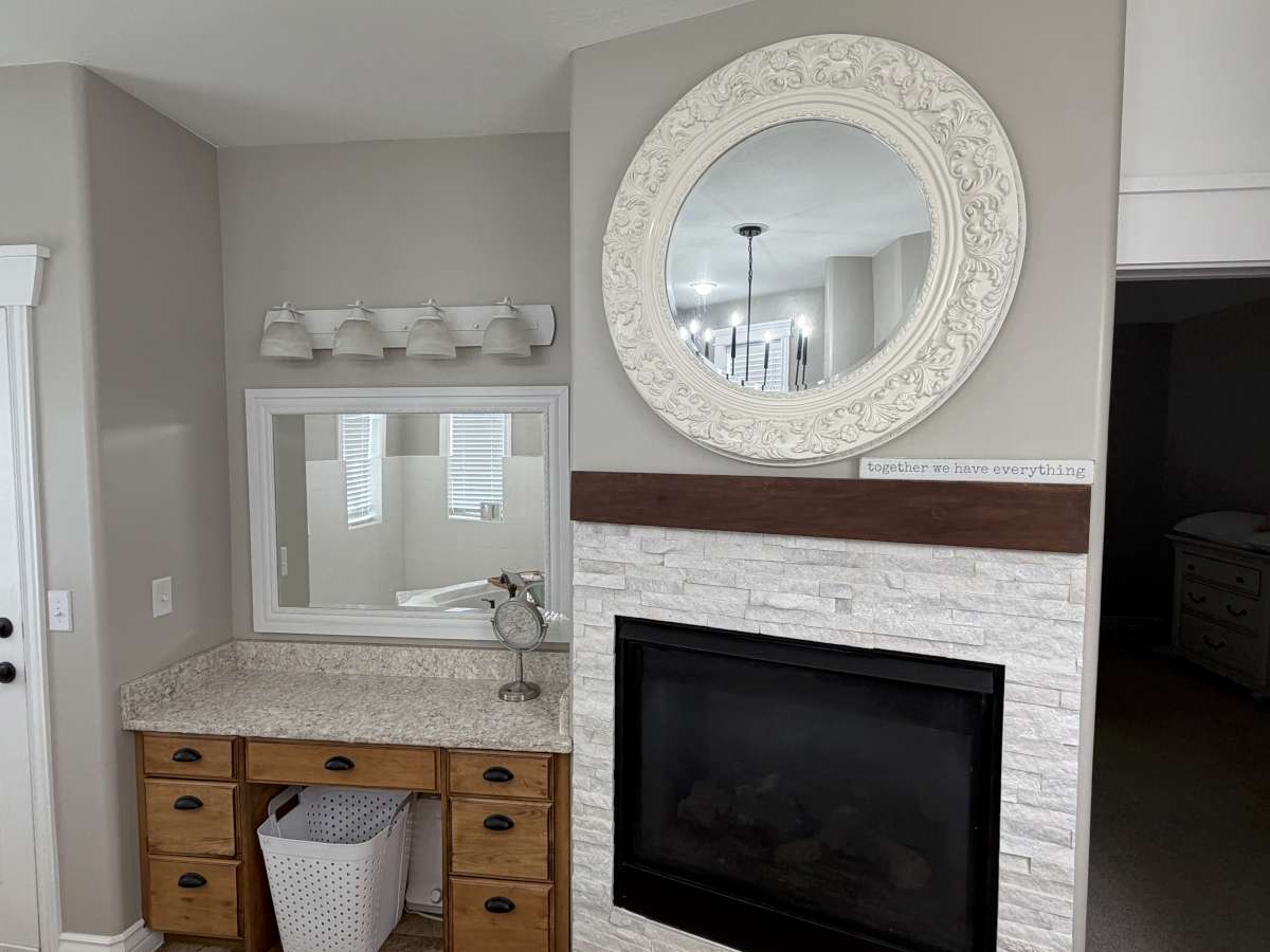 Bathroom featuring vanity and a stone fireplace