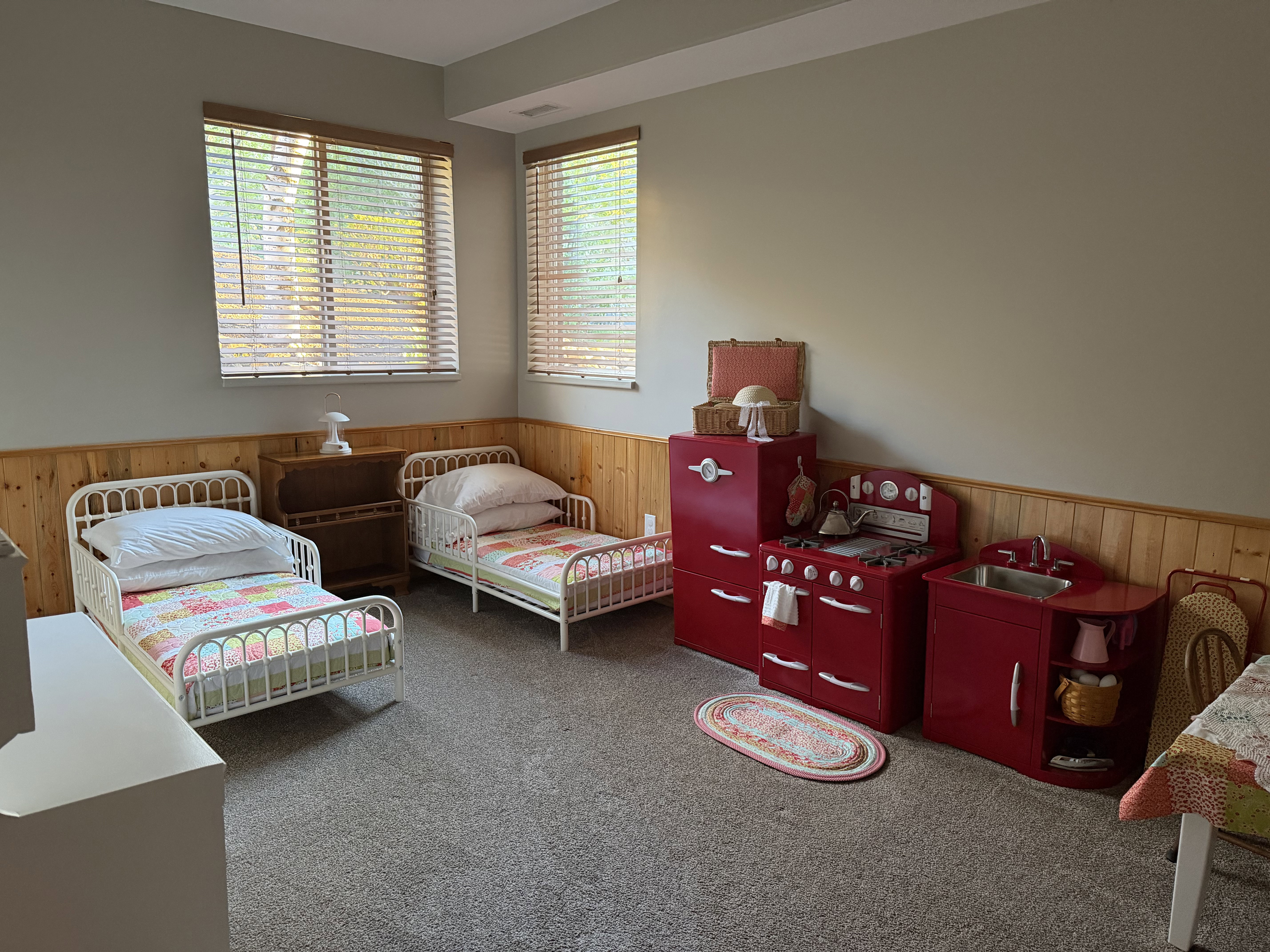Bedroom with wooden walls, carpet, and wainscoting