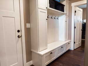 Mudroom with dark wood finished floors
