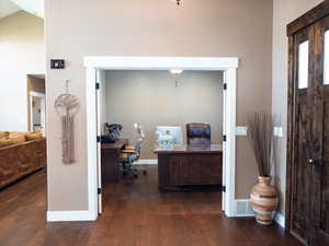 Office featuring dark wood finished floors and baseboards