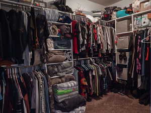 Walk in closet featuring dark carpet