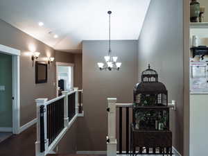Stairs with suspended lighting and wood finished floors