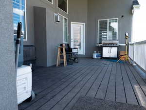 Wooden deck featuring a grill