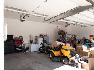 Garage featuring stainless steel fridge and freestanding refrigerator