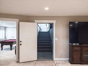 Staircase featuring billiards and recessed lighting
