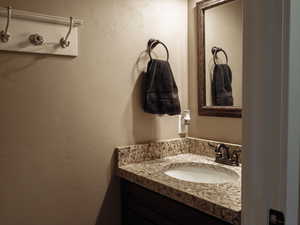 Bathroom with vanity and a textured wall