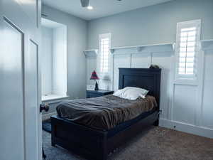 Carpeted bedroom with ceiling fan and recessed lighting