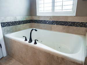 Bathroom with a tub with jets