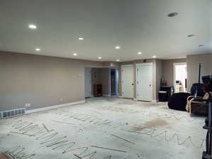 Living room featuring baseboards and recessed lighting