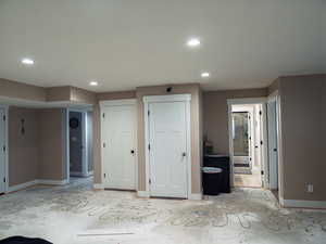 Unfurnished bedroom with ensuite bath, recessed lighting, and two closets