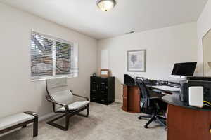 Office featuring light colored carpet and baseboards