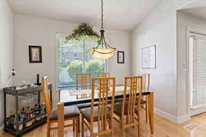 Dining space with light wood finished floors and baseboards