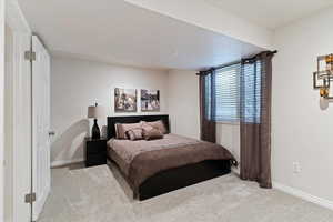 Bedroom featuring light colored carpet