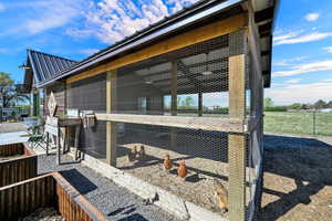 Chicken run with lights and exterior antique storm door for easy outside access