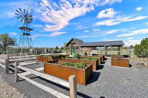 Raised garden beds and garden room with windmill (original to home, but decor use only)