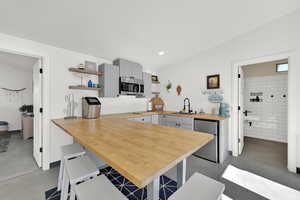 Large butcher block countertops for fun beachy feel and allows stools on all sides