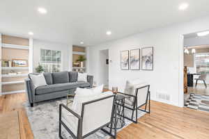 Living area with neutral colors and wood flooring