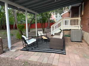Fenced backyard with a patio and outdoor lounge area