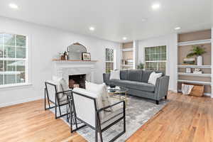 Living area featuring real wood fireplace in updated style