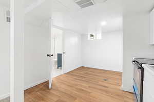 Basement with light wood finished floors and baseboards
